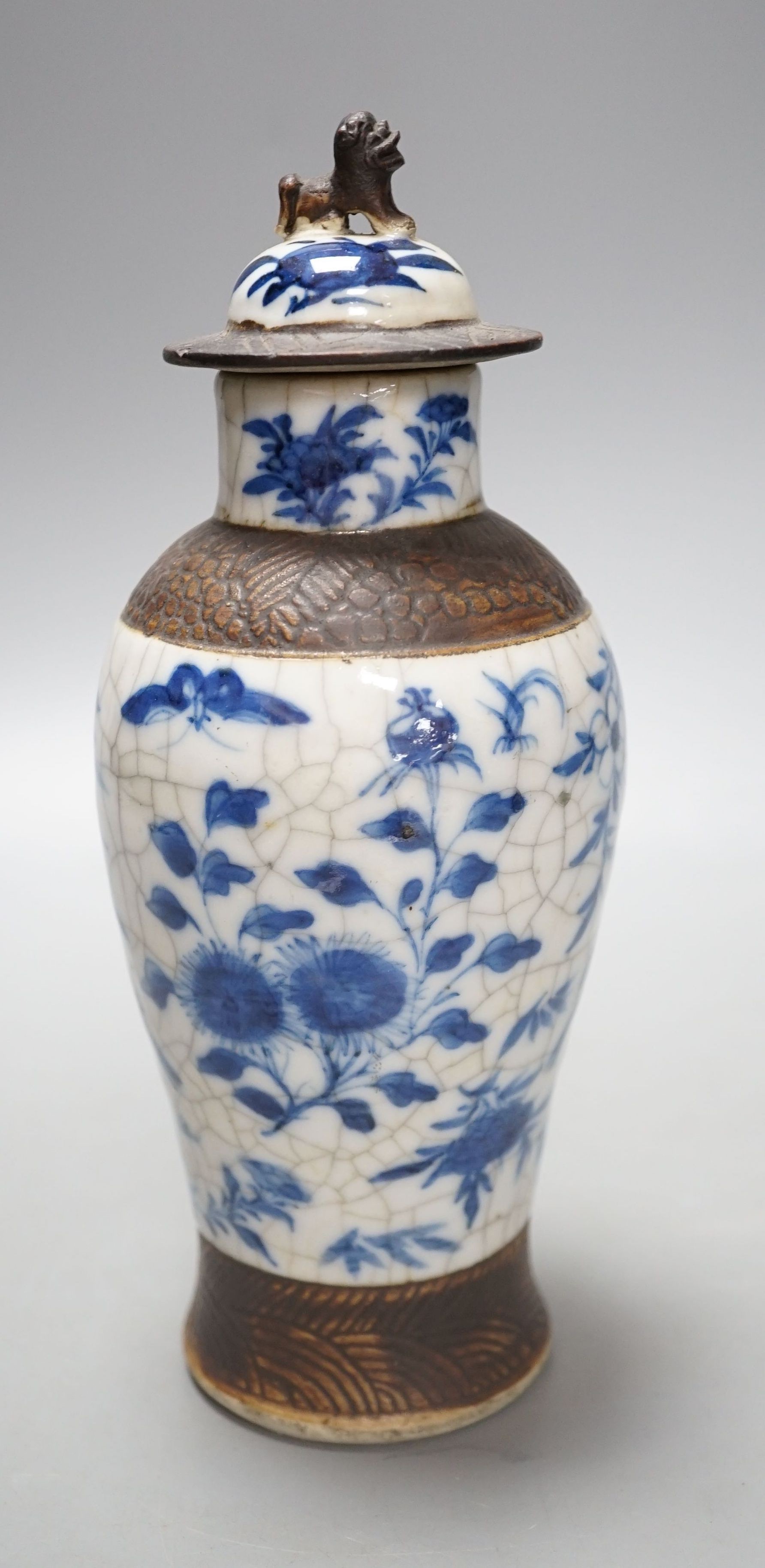 A Chinese blue and white crackle ware vase, c.1900, 22cms high including cover.